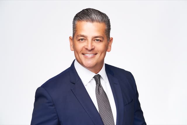 Professional headshot of mortgage lender in navy blazer - Oxnard